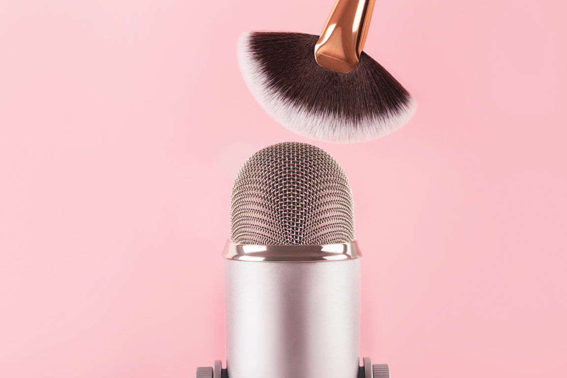 A makeup brush and a professional microphone on pink backround. Making ASMR sounds.